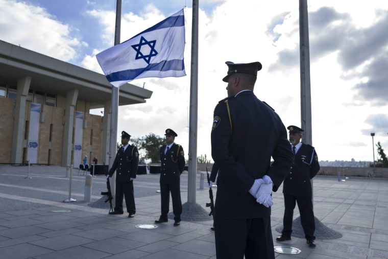 Image: Knesset in Jerusalem lowers flags to half mast honoring Shimon Peres
