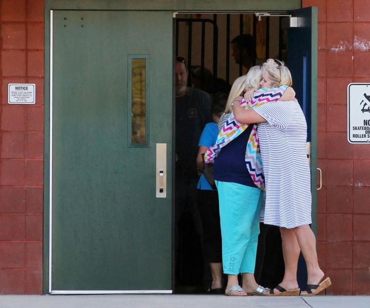 Image: Teachers hug outside Townville Elementary School