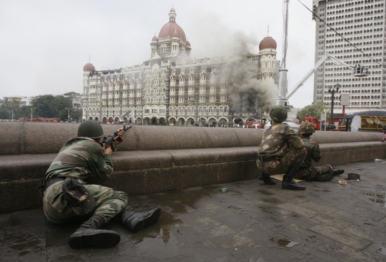 Image: Indian army soldiers take position during a gun battle at Taj Mahal hotel in Mumbai