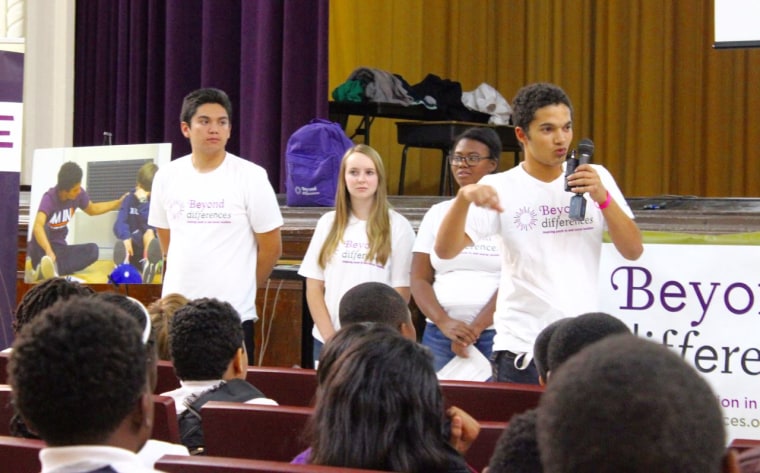 Students from Beyond Differences conducting a presentation at a school.