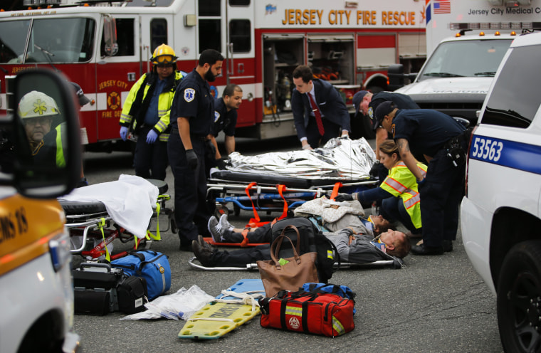 Image: People are treated for their injuries outside after a NJ Transit train crashed in to the platform