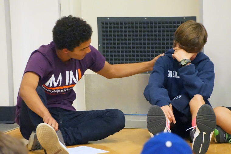 A student comforting another in a Beyond Differences demonstration.