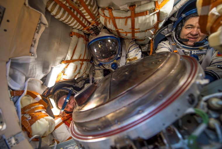 Image: The International Space Station (ISS) crew members are seen inside the Soyuz TMA-20M spacecraft capsule
