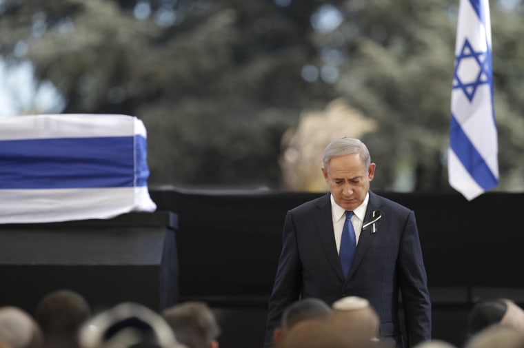 Image: Benjamin Netanyahu walks past the casket of Shimon Peres at Mount Herzl national cemetery, Friday.