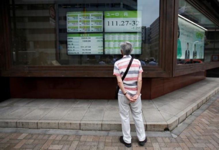 A man looks at an electronic board showing the Japanese yen's exchange rate against Euro outside a brokerage in Tokyo, Japan
