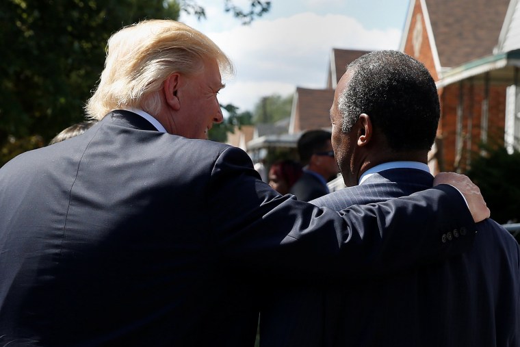 Image: Republican presidential nominee Donald Trump and Dr Ben Caron walk to Carson's childhood home in Detroit