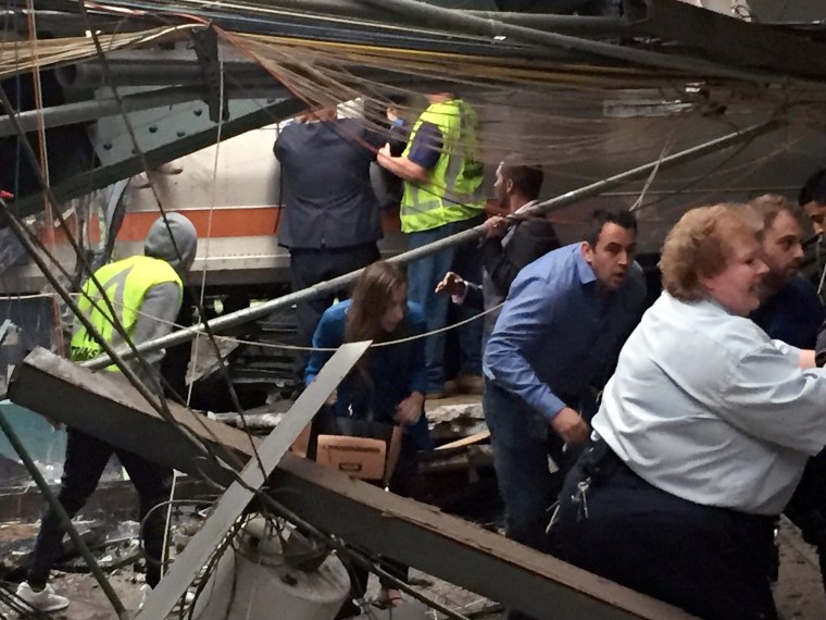 Image: Passengers rush to safety after a NJ Transit train crashed in to the platform at the Hoboken Terminal