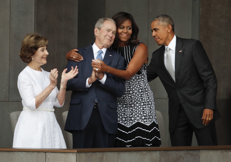Image: First lady Michelle Obama hugs former President George W. Bush at the dedication ceremony of the Smithsonian Museum of African American History and Culture