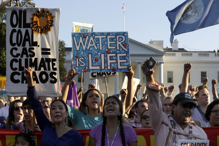 Supporters of the Standing Rock Sioux Tribe rally in opposition of the Dakota Access oil pipeline in front of the White House, Tuesday, Sept. 13, 2016, in Washington. The company developing the $3.8 billion Dakota Access pipeline says it is committed to the project, despite strong opposition and a federal order to halt construction near an American Indian reservation in North Dakota. (AP Photo/Jacquelyn Martin)