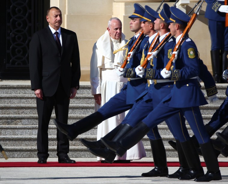 Image: Pope Francis and Azerbaijan's President Ilham Aliyev review the honour during a meeting at the Presidential Palace in Ganjlik