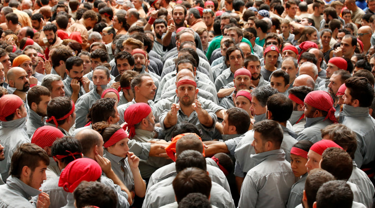Image: Castellers de Sants start to form a human tower called \"castell\" during a biannual competition in Tarragona city