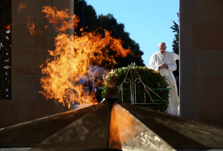 Image: Pope Francis prays in front of the monument to the fallen for the Indipendence in Ganjlik