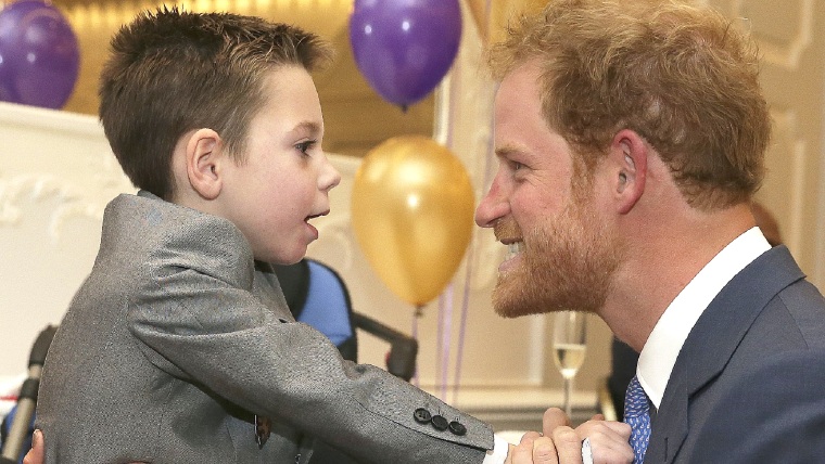 Prince Harry  with Ollie Carroll, a WellChild award recipient.