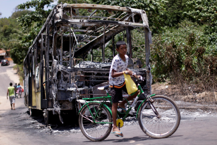 Image: A bus is pictured after it was set on fire during violent disturbances ahead of municipal elections in Sao Luis