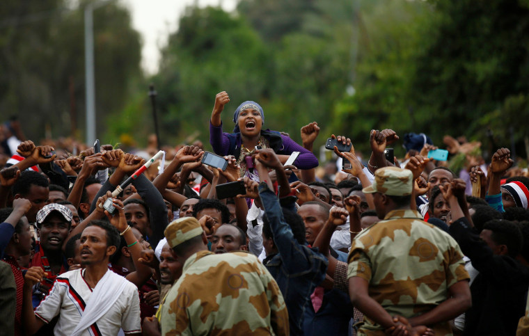 Image: Demonstrators chant slogans while flashing the Oromo protest gesture during Irreecha, the thanksgiving festival of the Oromo people, in Bishoftu town, Oromia region, Ethiopia