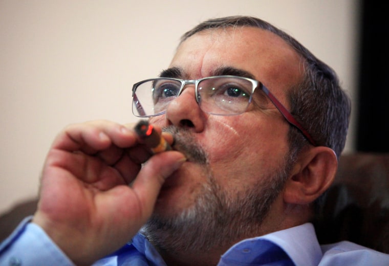 Image: FARC rebel leader Rodrigo Londono smokes a Cohiba cigar while watching a live transmission of the referendum on a peace deal, in Havana, Cuba