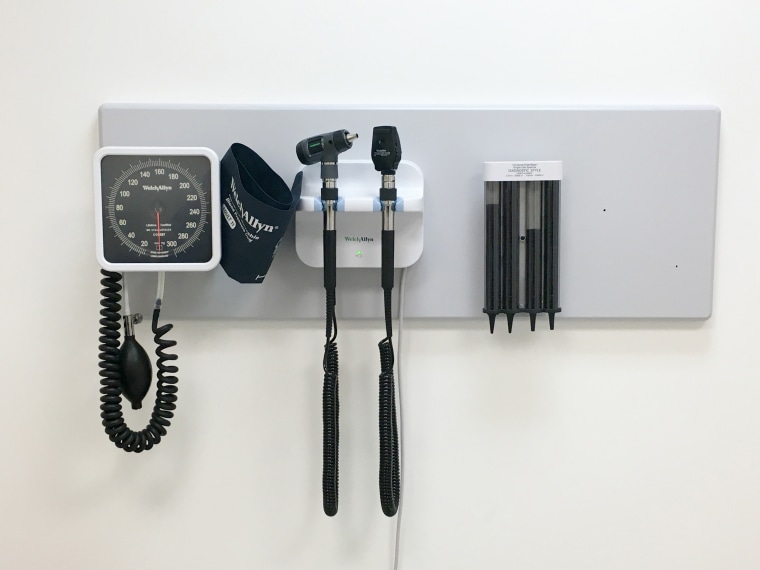 Inside doctor's office with basic equipment on the wall.