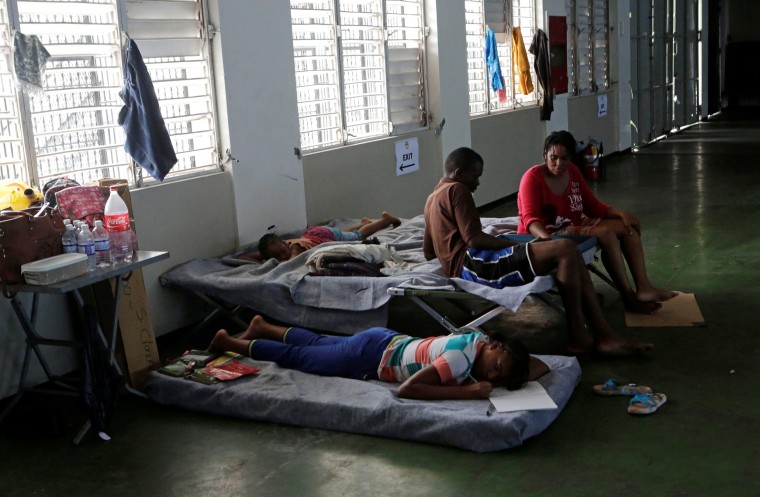Image: People who were evacuated from their homes are seen in a room at a soccer stadium being used as a shelter while Hurricane Matthew approaches Kingston