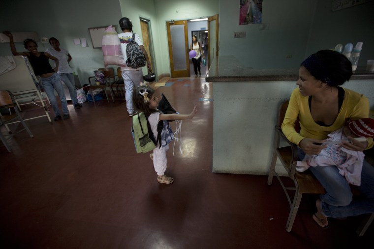 In this Sept. 19, 2016 photo, 3-year-old Ashley Pacheco waves goodbye after she was discharged from University Hospital in Caracas, Venezuela.