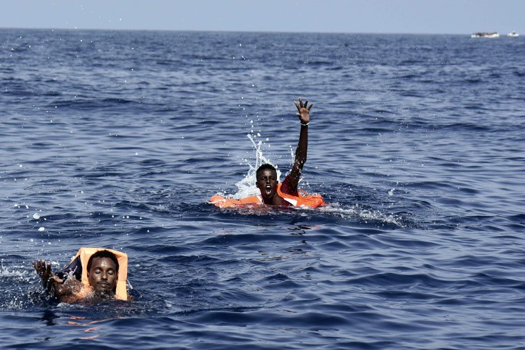Image: Migrants wait to be rescued in the Mediterranean sea on Tuesday.