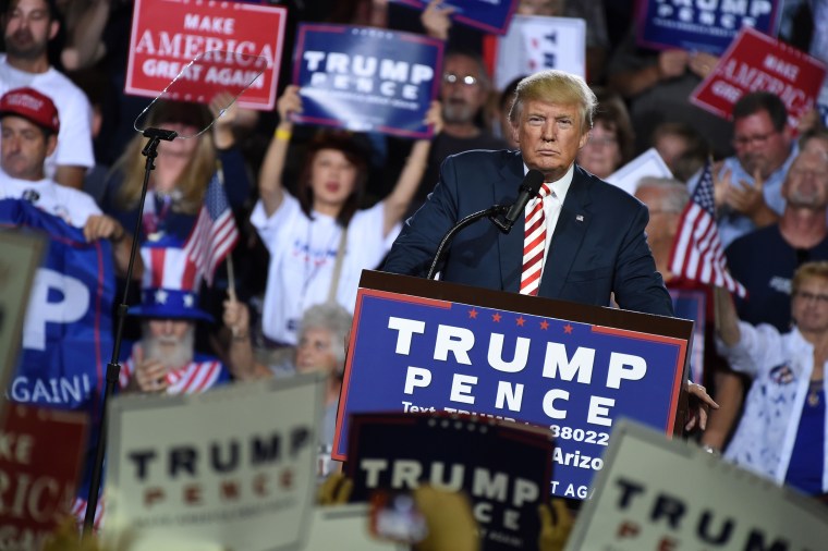 Image: Republican presidential candidate Donald Trump looks on during a campaign rally at the Prescott Valley Event Center