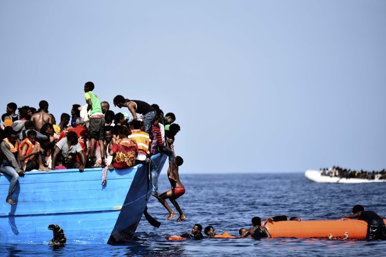 Image: Migrants wait to be rescued by members of Proactiva Open Arms NGO