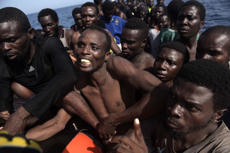 Image: Migrants wait to be rescued by members of Proactiva Open Arms NGO