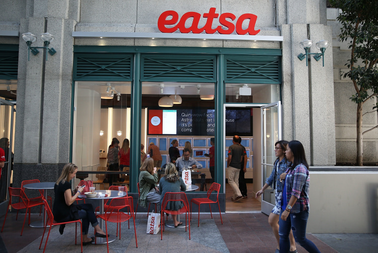 Image: People walk by eatsa, a fully automated fast food restaurant