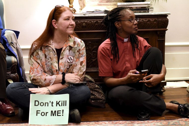 Demonstrators gather to protest the scheduled execution of convicted murderer Richard Glossip, inside Governor Mary Fallin's office at the state capitol in Oklahoma City, Oklahoma