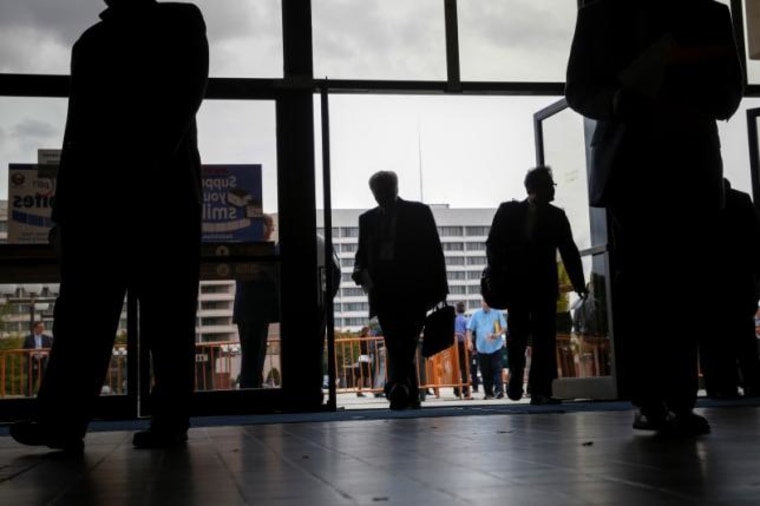 People enter the Nassau County Mega Job Fair at Nassau Veterans Memorial Coliseum in Uniondale, New York