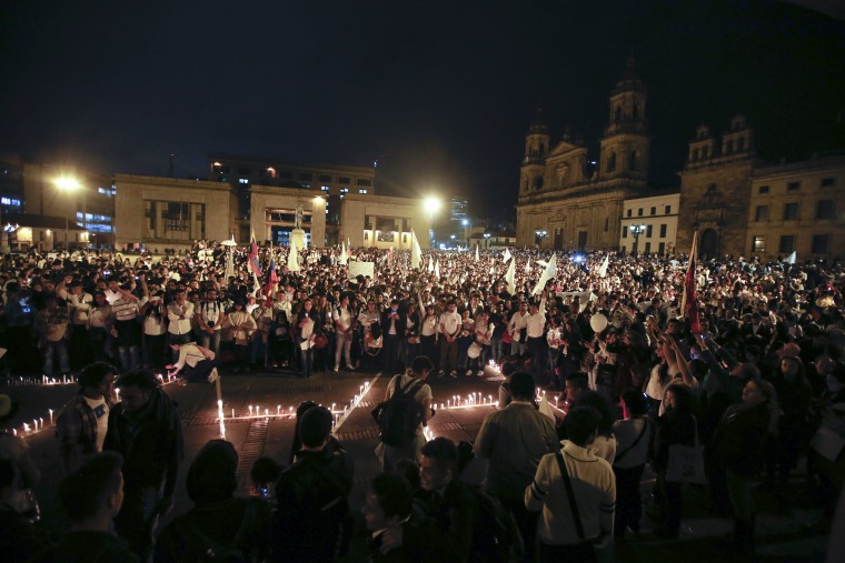 Demonstrators light candles during a march for peace in Bogota, Colombia, Wednesday, Oct. 5, 2016. The march was organized on social media by student groups and social movements to ask the political establishment and leftist rebels to not give up on a peace deal that was narrowly rejected by voters in a referendum on Oct. 2.  (AP Photo/Fernando Vergara)