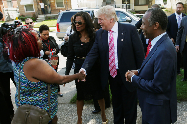 Image: Republican presidential nominee Donald Trump speaks with homeowner Felicia Reese and Dr. Ben Carson in front of Carson's childhood home in Detroit