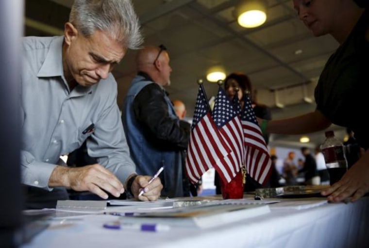 A job seeker fills out papers at a military job fair in San Francisco
