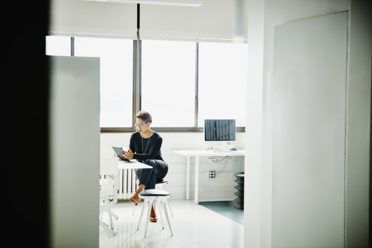 Female business owner working on digital tablet