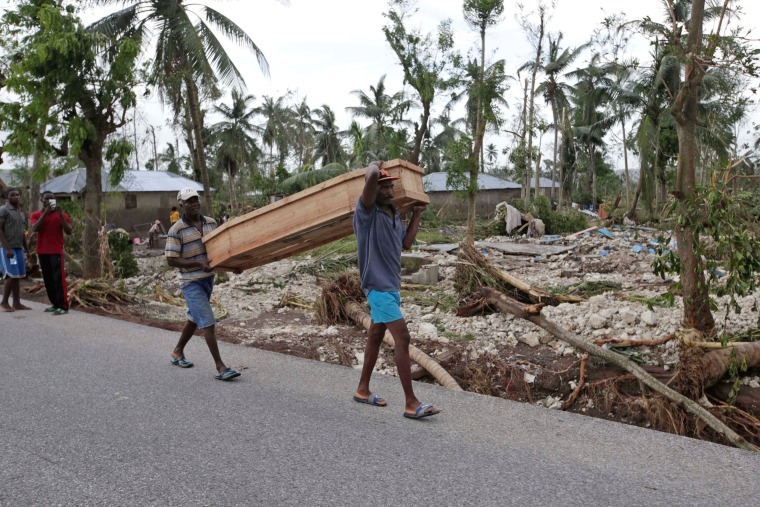 Image: Men carry a coffin after Hurricane Matthew hit Cavaillon, Haiti