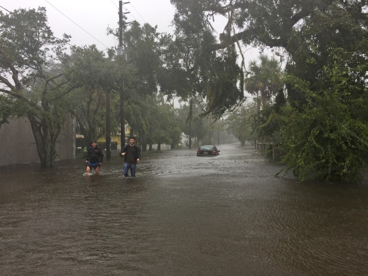 Two men walk through floodwaters in historic Saint Augustine on Bayview Drive on Oct. 7 as Hurricane Matthew worked its way up the Florida coast.