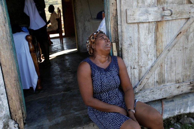 Image: A relative cries before the funeral of Anne Dit Trozitha Zamore, who died during Hurricane Matthew, in Chantal, Haiti
