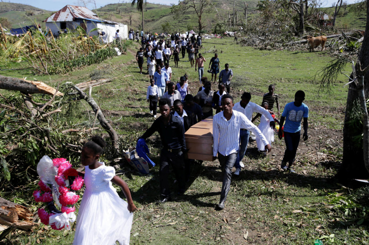 Image: Friends and relatives attend the funeral of Anne Dit Trozitha Zamore, who died during Hurricane Matthew, in Chantal, Haiti