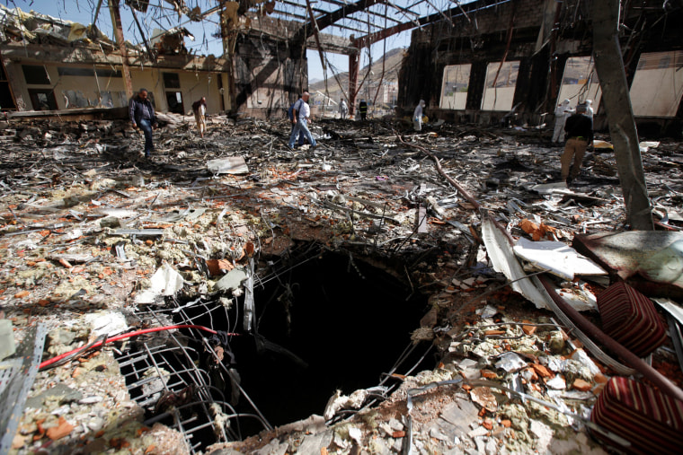 Image: Journalists and policemen inspect the secene at the community hall where Saudi-led warplanes struck a funeral in Sanaa, the capital of Yemen