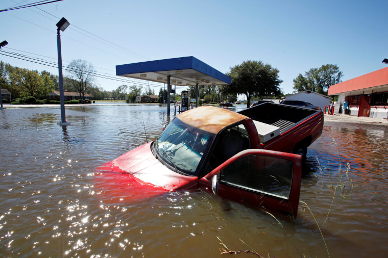 Image: An abandoned truck lies in submerged waters after Hurricane Matthew hit Lumberton, North Carolina