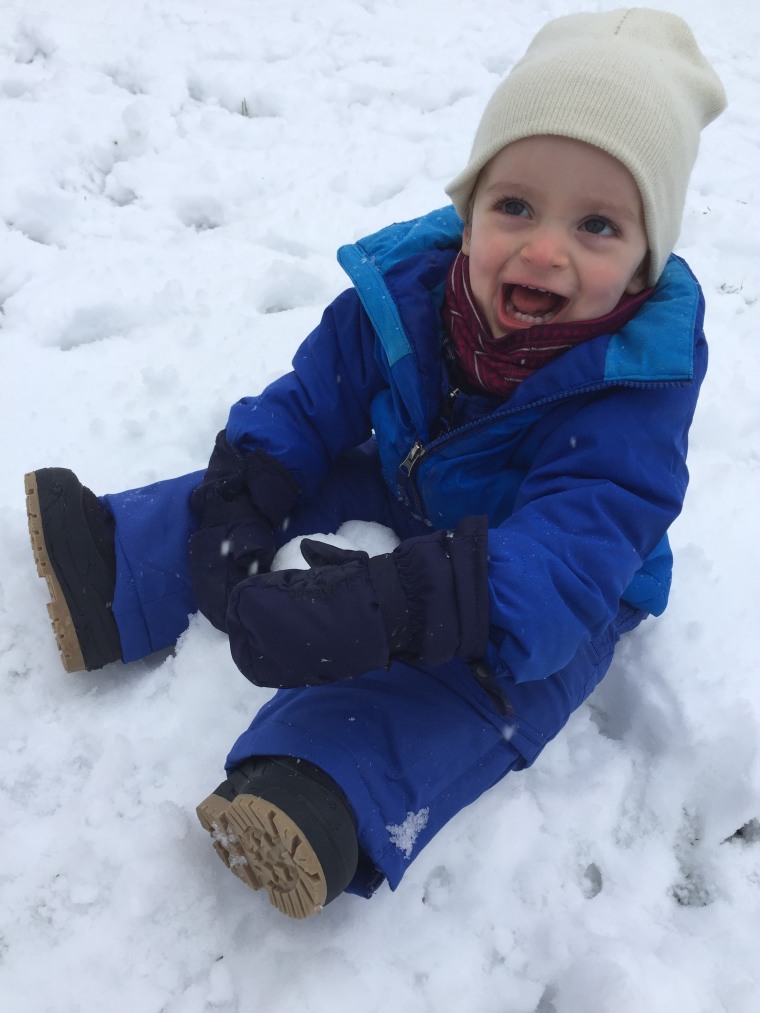 Cold? Snow? Who cares? Theo shows his love for the outdoors with lots of laughs and smiles.