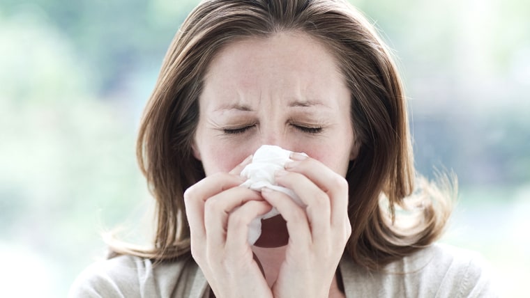 woman blowing her nose