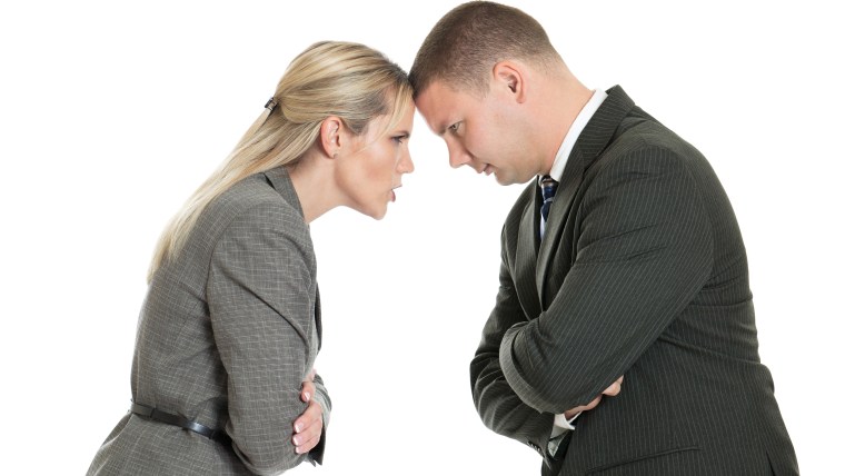 Angry male and female business people butting heads