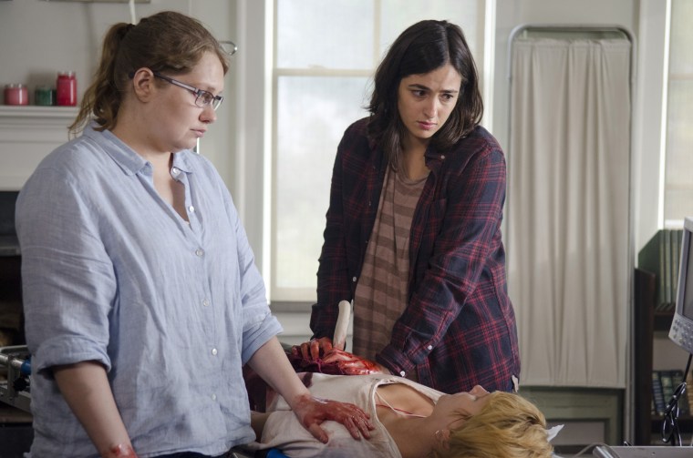 Dr. Denise Cloyd (Merritt Wever) and Tara Chamber (Alanna Masterson) trying to save Holly (Laura Beamer) on "The Walking Dead."