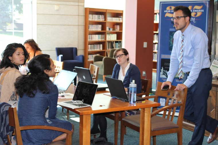 Workshop participants learning how to collect and create stories at a workshop at the Arab American National Museum.