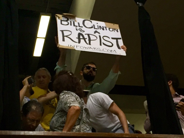 Image: A protester interrupts Hillary Clinton during a Tuesday night rally in Miami, Florida.