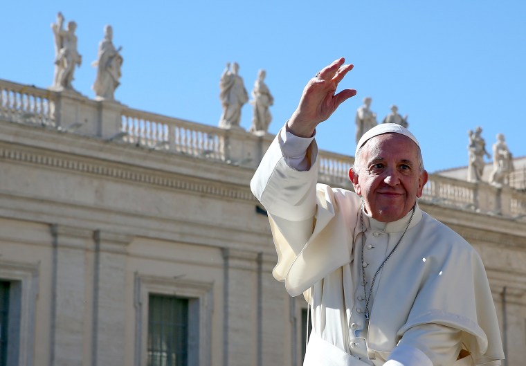 Image: Pope Francis waves at the end of his weekly audience at the Vatican