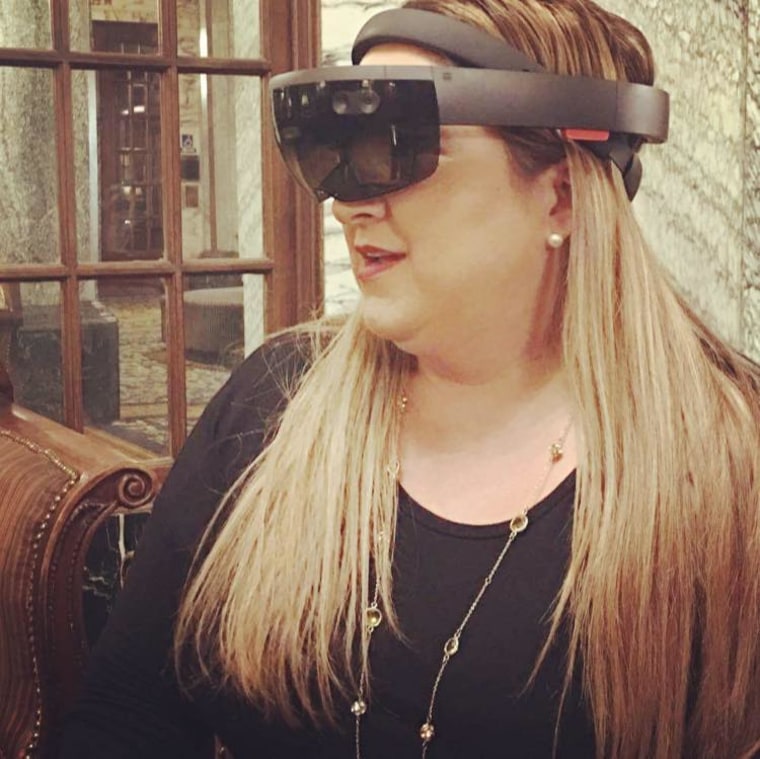 Cathy Hackl using a Holo Lens virtual reality headset.
