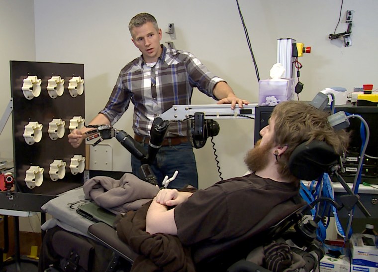 Researcher Rob Gaunt prepares Nathan Copeland for brain computer interface sensory test. This material relates to a paper that appeared in the Oct. 12 October issue of Science Translational Medicine, published by AAAS. The paper, by S.N. Flesher at University of Pittsburgh in Pittsburgh, PA, and colleagues was titled, "Intracortical microstimulation of human somatosensory cortex."