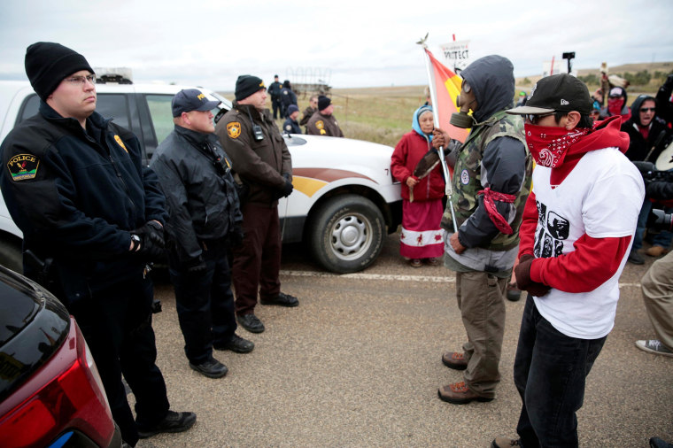 Image: Dakota Access Pipeline protesters square off against police between the Standing Rock Reservation and the pipeline route outside the little town of Saint Anthony